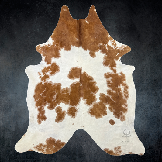 Brown and white cowhide rug