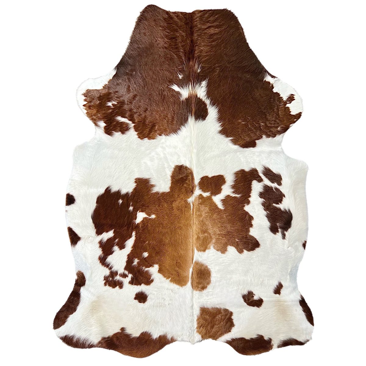 brown and white cowhide rug