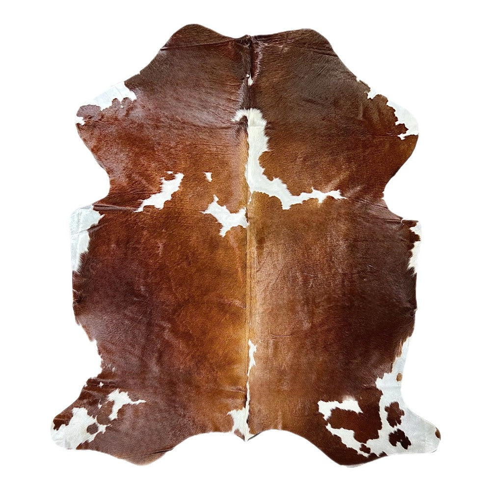 brown and white cowhide rug