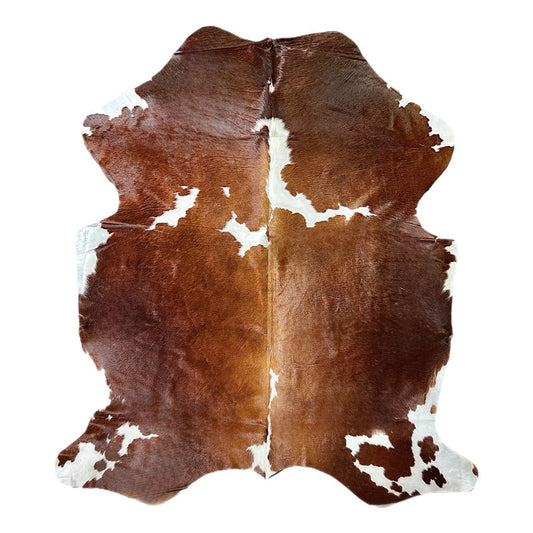 brown and white cowhide rug